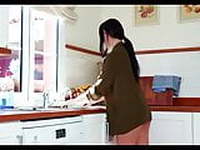 Beautiful girl whit black hair having fun in the kitchen