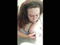 Busty mixed race woman pumping milk from her big nipples