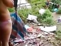 Chinese village women change the cloths in the lake side