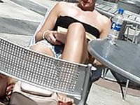 Blonde bombshell sunbathing her legs and feet 