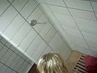 Blonde girl taking a shower